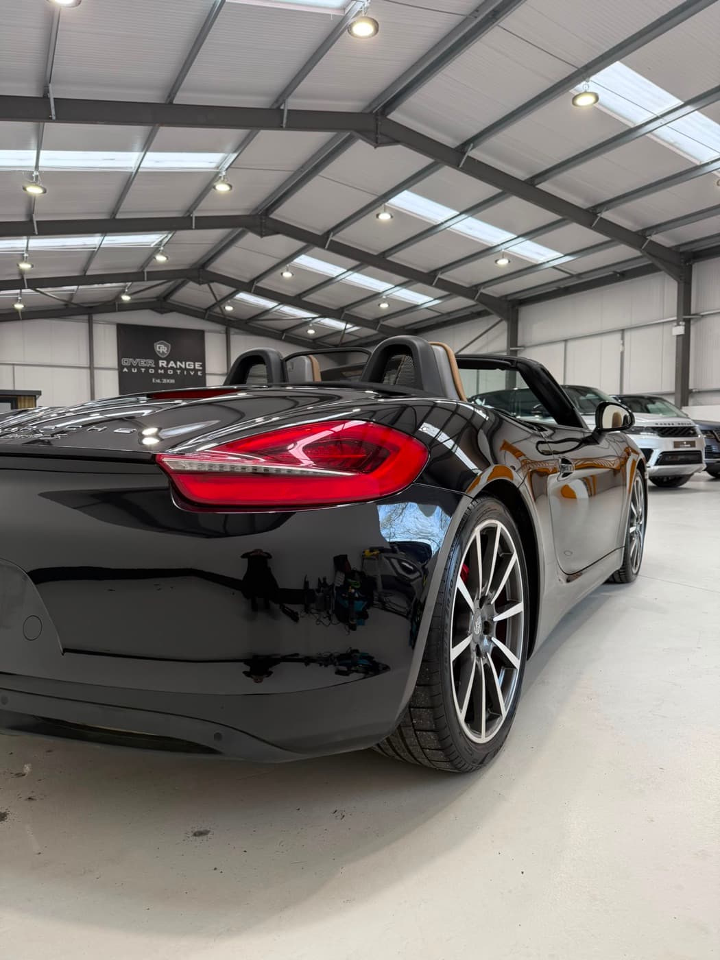 Black Porsche Boxster gleaming after detailing